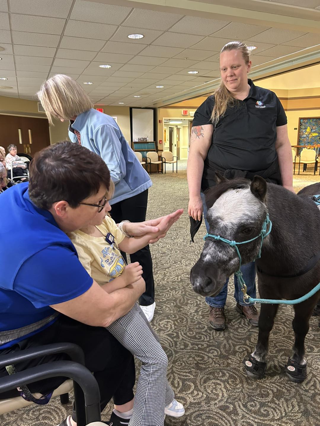 A senior living resident meeting Sir Camelot indoors