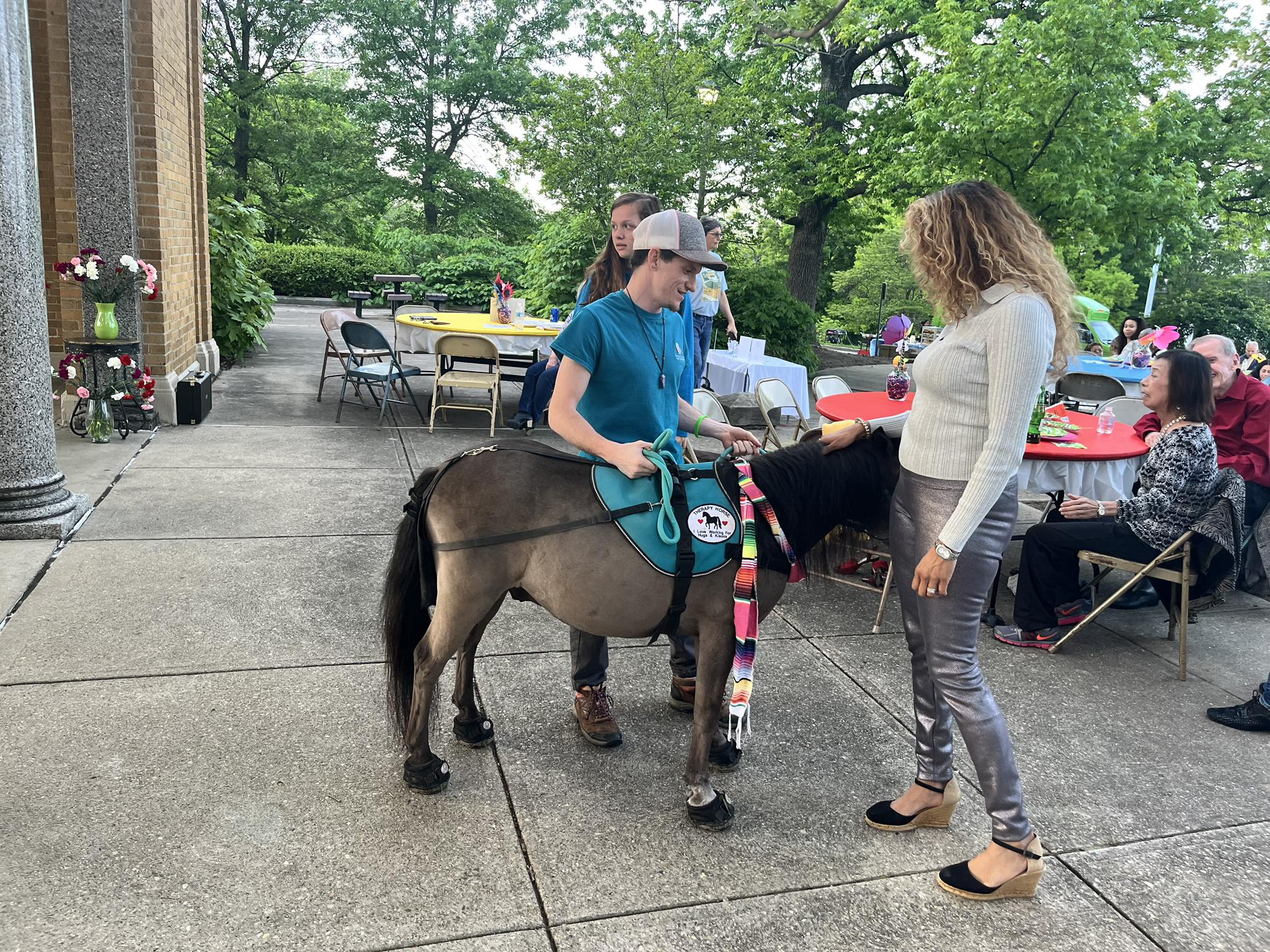 Sir Camelot greeting a guest during an outdoor gala
