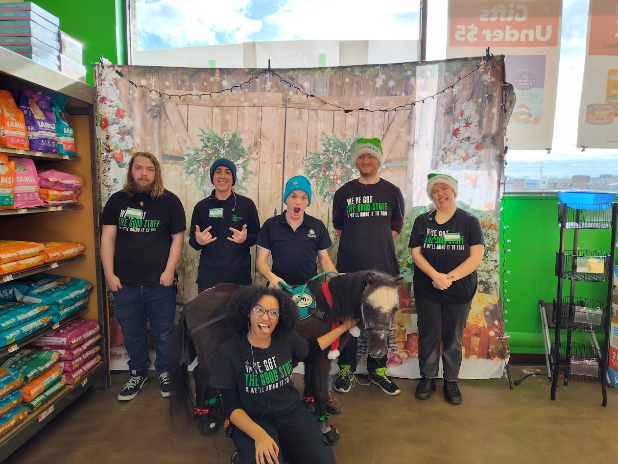 Sir Camelot with the Pet Supplies Plus team during a business visit