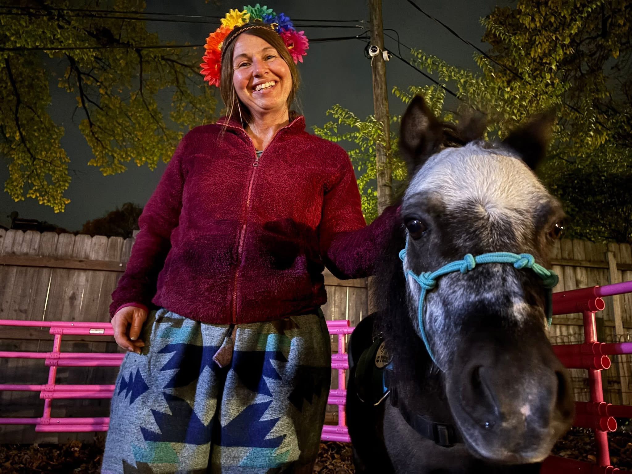 Melissa smiling with Sir Camelot during a wellness gathering
